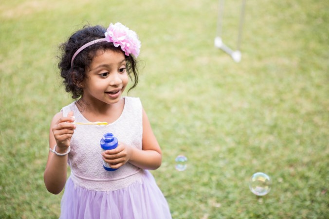 girl blowing bubbles