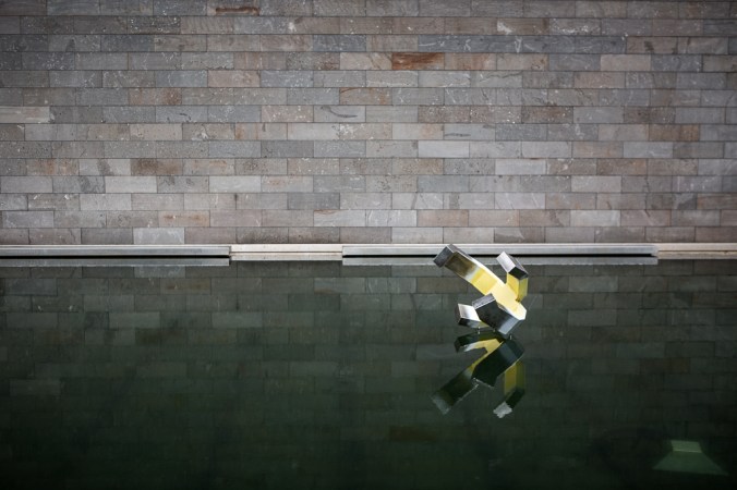 art in water with stone wall