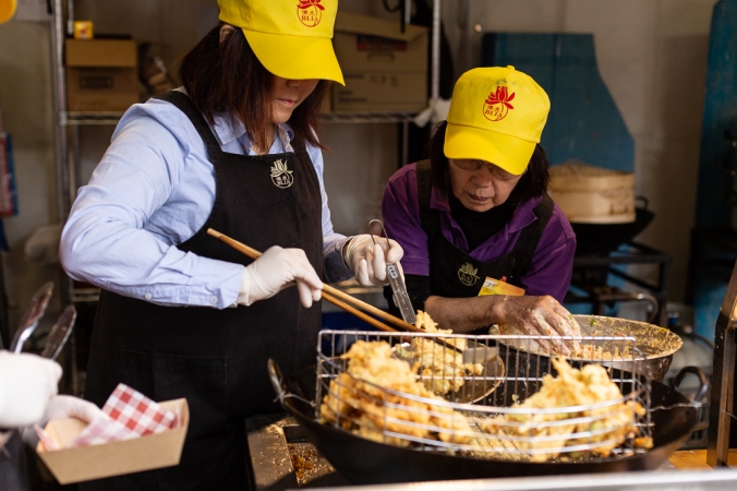 women cooking tempura at buddha festival